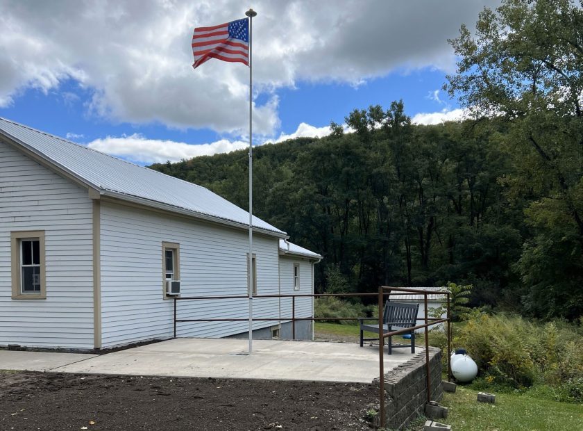 Town of Hartsville memorial area for Darold "Buddy" Getman, paved area with flag pole flying the American flag next to the Town of Hartsville office